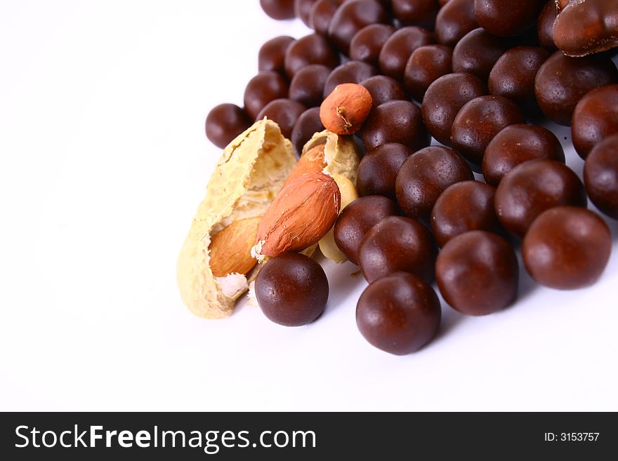 Black and brown chocolate sweets against white background