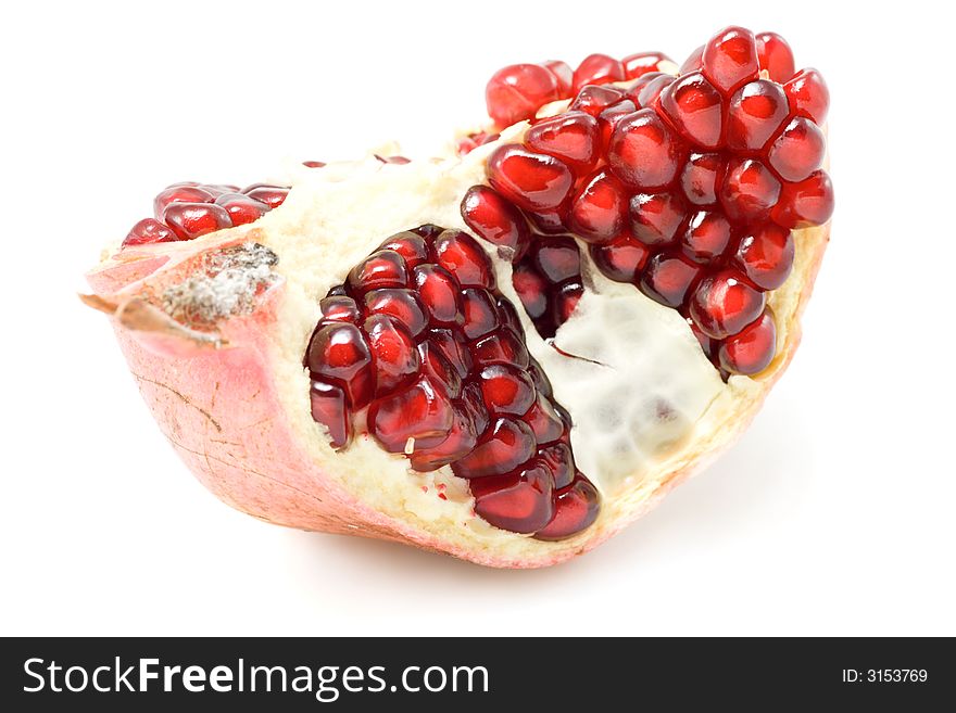 Piece of ripe pomegranate isolated on white background.