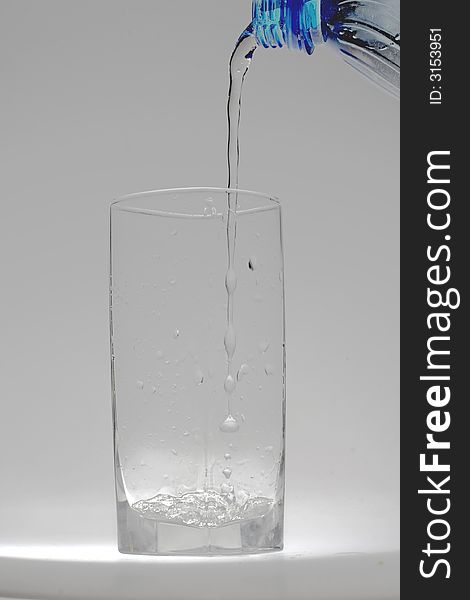 Jet of transparent water flowing in a glass and doing there water mixed with small bubbles. Jet of transparent water flowing in a glass and doing there water mixed with small bubbles