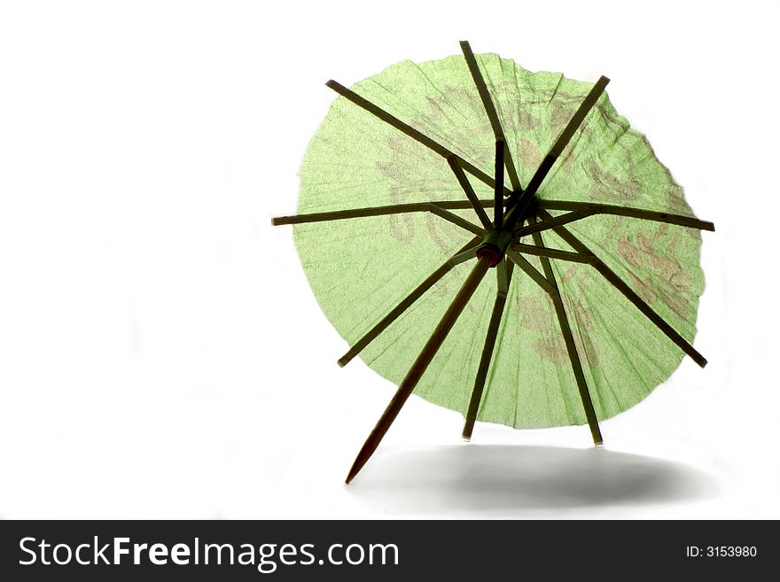 Backlit green paper umbrella over white background. Backlit green paper umbrella over white background