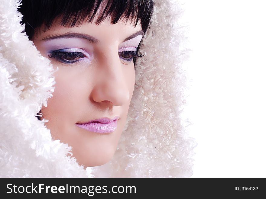 Close up of a woman with white fur draped over her black hair. Close up of a woman with white fur draped over her black hair
