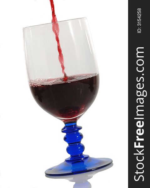 Red wine pouring down into a wine glass