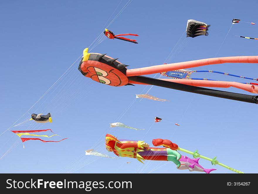 Colorful kites flying to the wind in blue sky