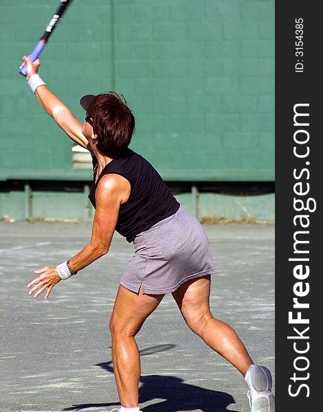 Female tennis player serving the ball