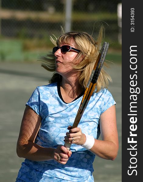 Female tennis player with hair blowing from movement. Female tennis player with hair blowing from movement