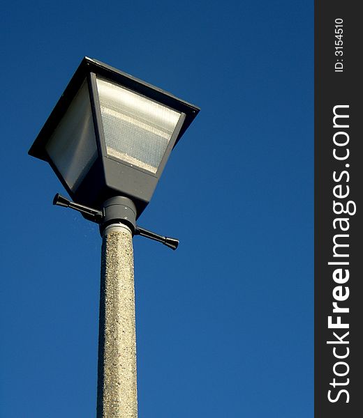 Outdoor lamp against blue sky during the bright daylight. Outdoor lamp against blue sky during the bright daylight.