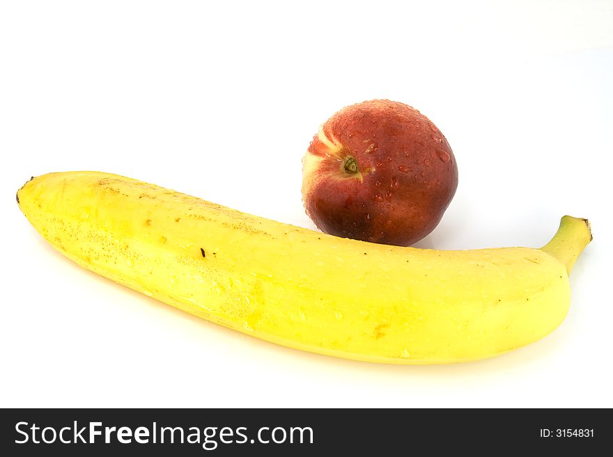 Banana with peach isolated over white background