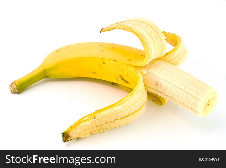Half peeled banana isolated over white background with some shadow
