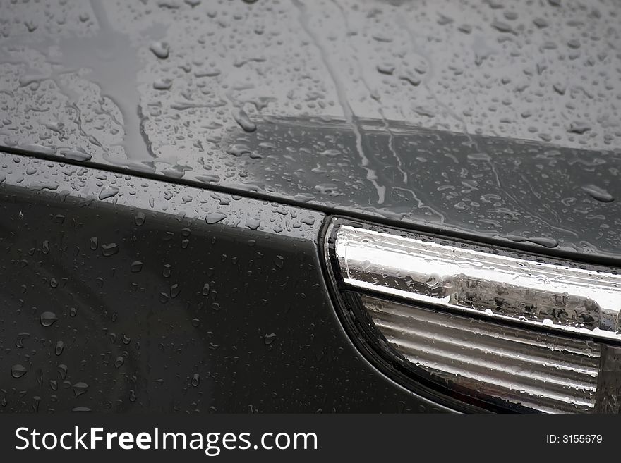 Water drops on black car surface. Water drops on black car surface.