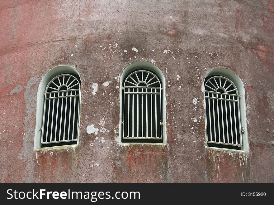 Arched iron windows taken from exterior of tower. Arched iron windows taken from exterior of tower