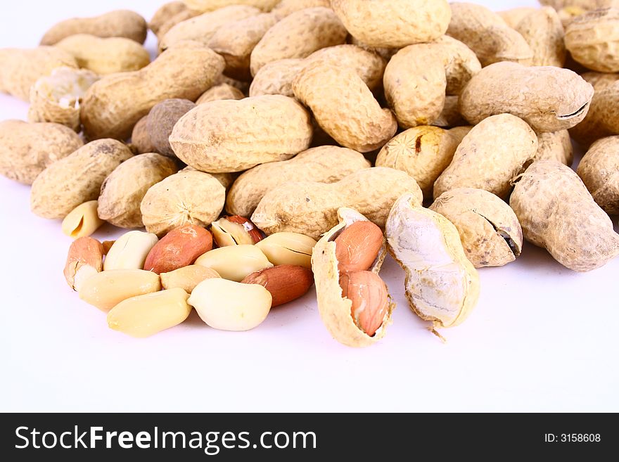 Brown peanut some peanuts over white background