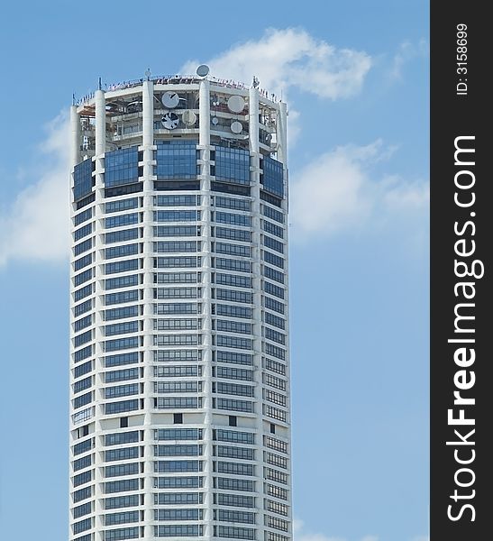 High-rise, circular office building with parabolic antennas at the top floors. Georgetown, penang, malaysia. High-rise, circular office building with parabolic antennas at the top floors. Georgetown, penang, malaysia.