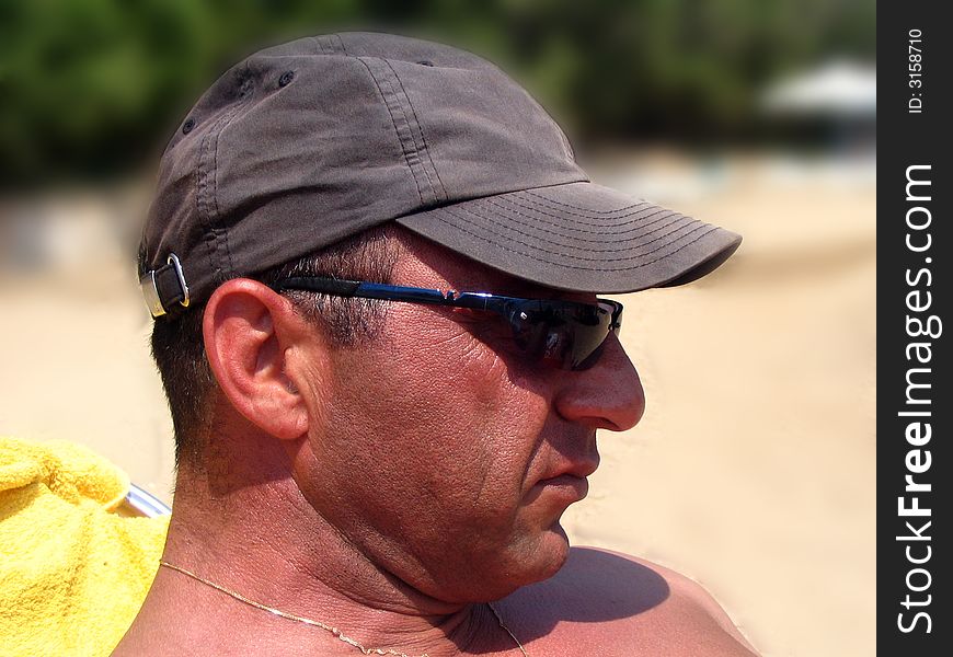 A man's headshot at the beach. Background blurred. A man's headshot at the beach. Background blurred