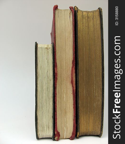 Photo of 3 old worn stacked books. Photo of 3 old worn stacked books