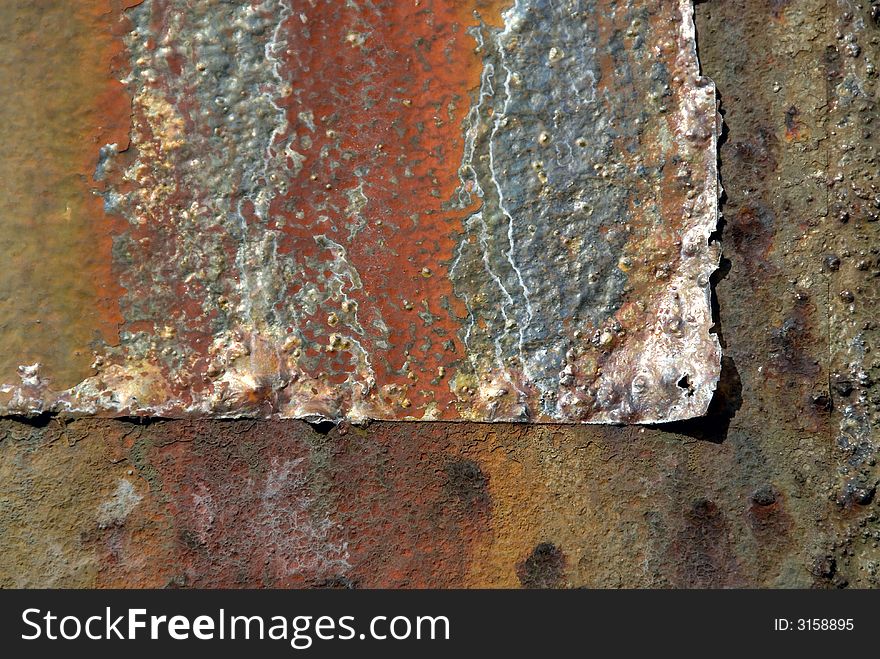 Colorfully weather-beaten rust on old steel construction shining in the sun
