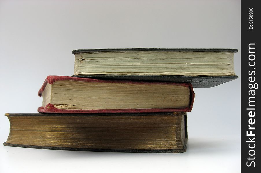 Photo of 3 old worn stacked books. Photo of 3 old worn stacked books