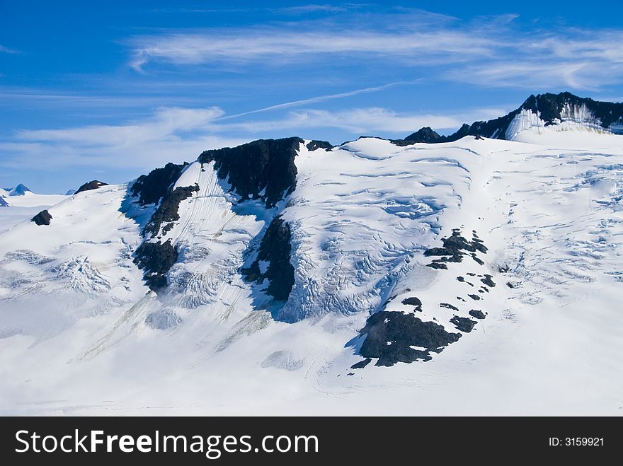 Mountain peaks above the snow and clouds near Skagway Alaska. Mountain peaks above the snow and clouds near Skagway Alaska