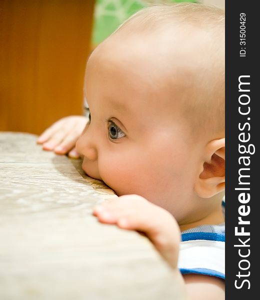 Kid in a chair chewing profile. Kid in a chair chewing profile