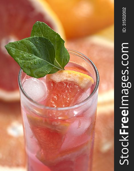 Fresh and cold ice tea with sliced grapefruit and mint