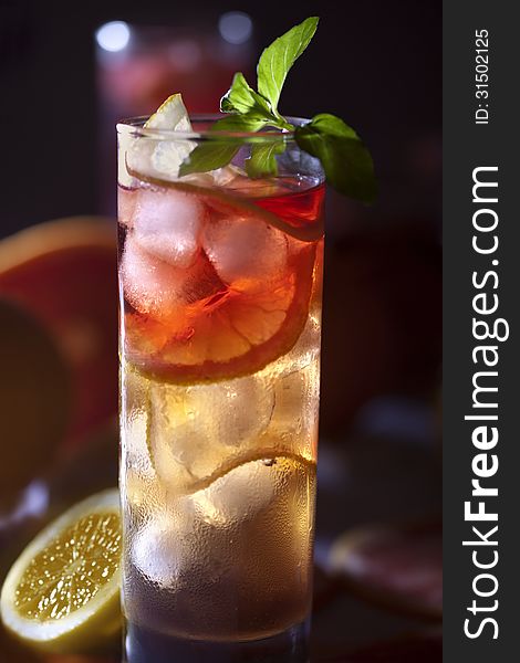 Fresh and cold ice tea with sliced grapefruit, lemon and mint