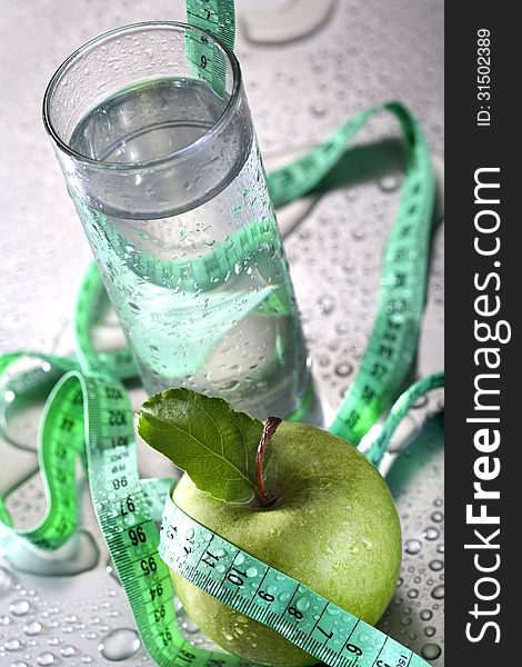 Healthy concept - apple glass of water and tape. Healthy concept - apple glass of water and tape