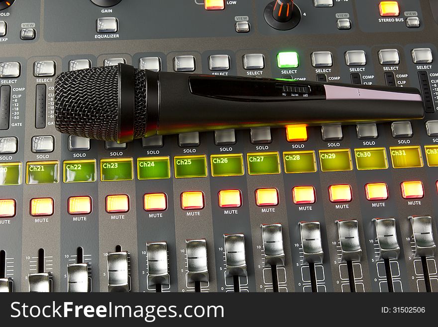 Microphone on the top portion of a digital audio mixer. Microphone on the top portion of a digital audio mixer