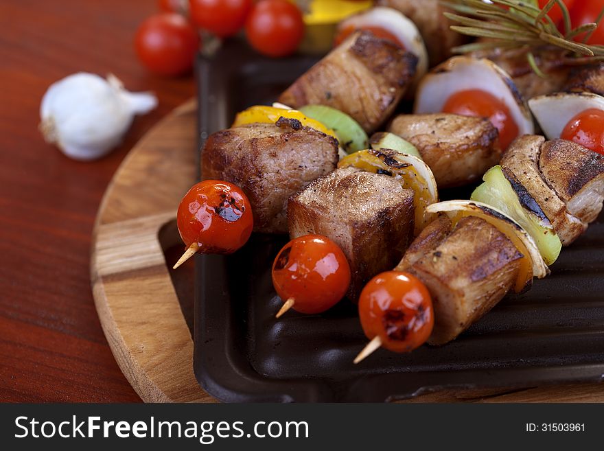 Meat and vegetable skewers on plate