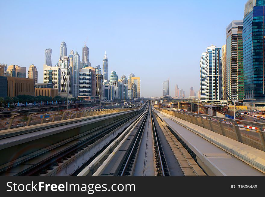 Dubai metro mainly ground. The picture was taken from the last wagon, where the panoramic view of the city. Dubai metro mainly ground. The picture was taken from the last wagon, where the panoramic view of the city.