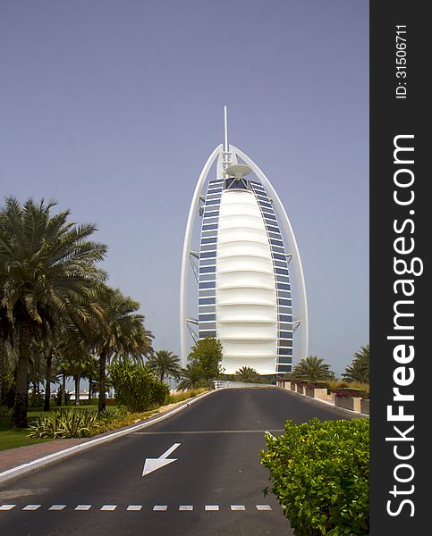 Burj al Arab ( literally Â«the Arab TowerÂ») - luxury hotel in Dubai. The building stands in the sea at the distance of 280 metres from the coast on an artificial island connected to the mainland by using the bridge. Burj al Arab ( literally Â«the Arab TowerÂ») - luxury hotel in Dubai. The building stands in the sea at the distance of 280 metres from the coast on an artificial island connected to the mainland by using the bridge.