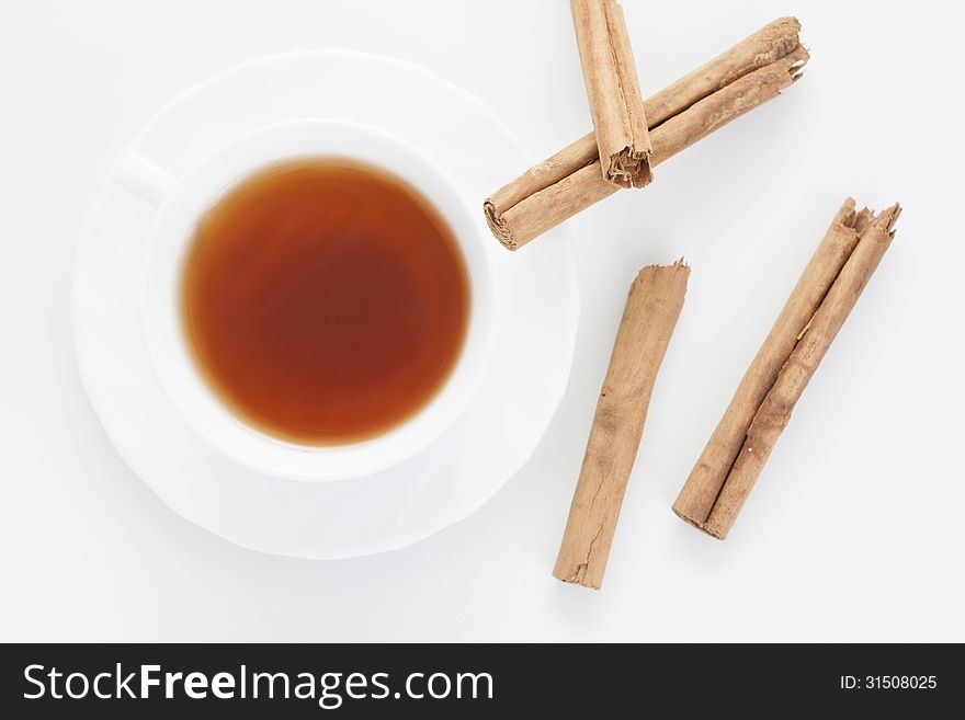 Cup of red tea with cinnamon from above with white background