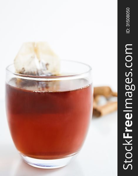 Cup of red tea with cinnamon from above with white background. Cup of red tea with cinnamon from above with white background