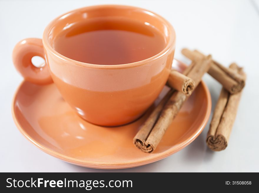 Cup of red tea with cinnamon from above with white background. Cup of red tea with cinnamon from above with white background