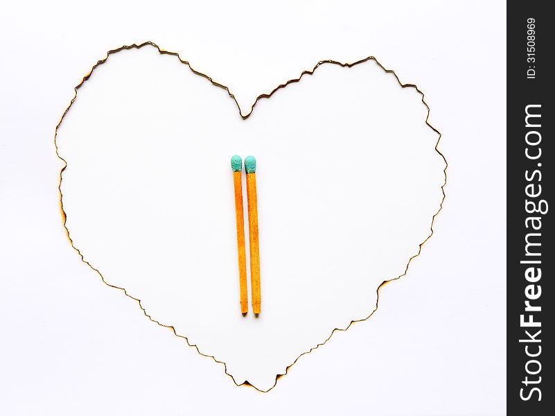 Blue matchsticks and heart shape on white background