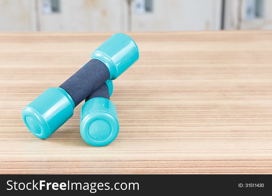 Samall Fitness dumbbells on the desk wooden