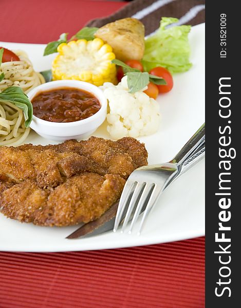 Fried chicken dish on red background