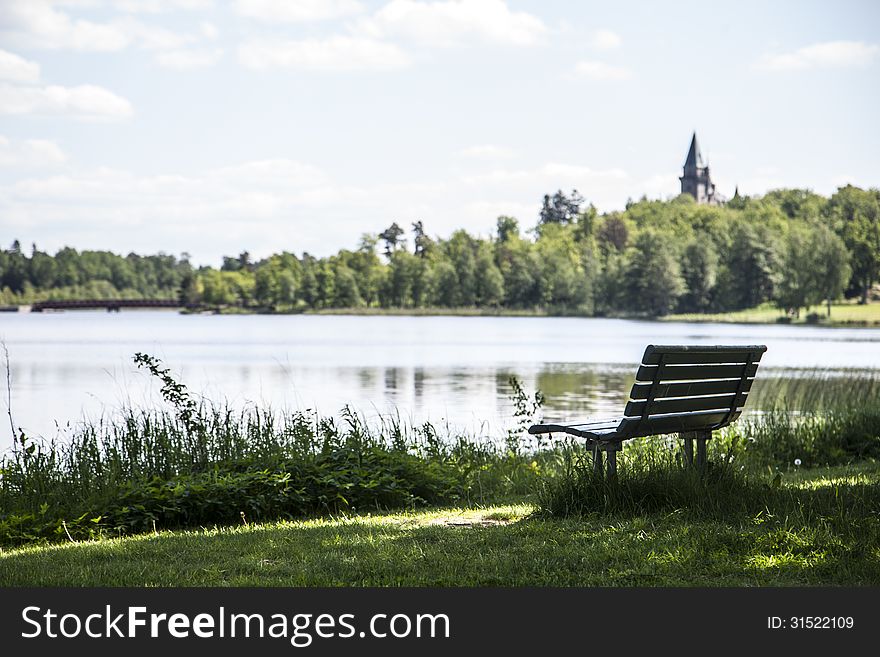 Bench by the lake with forest