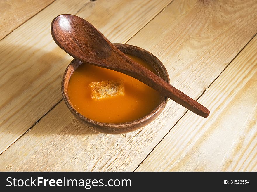 Vegetable Tomato Soup in wooden bowl