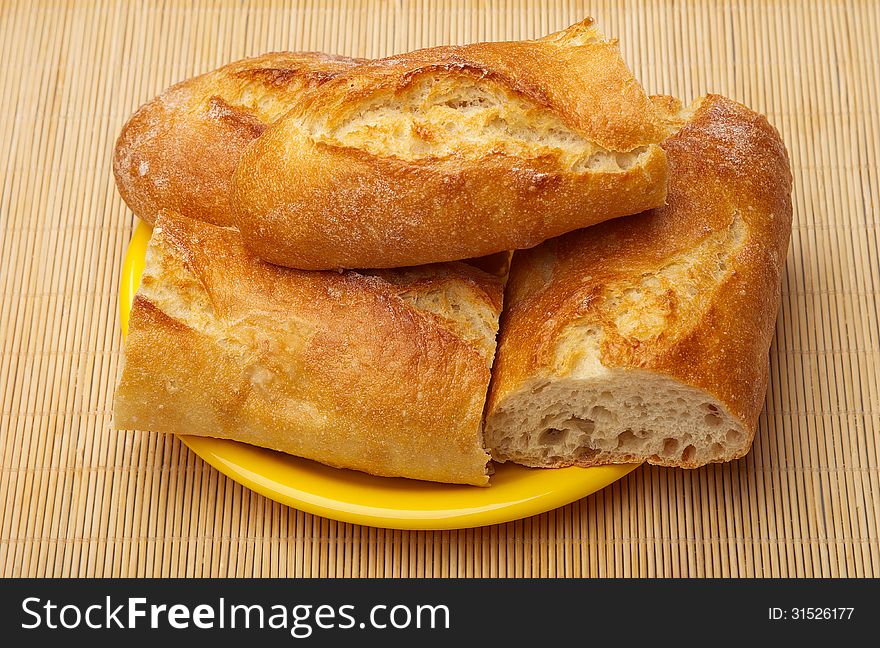 Fresh Crusty the cut baguettes on a wooden background.