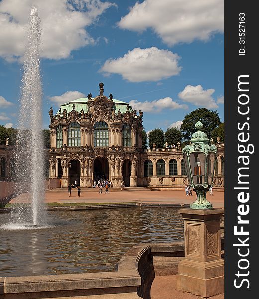 Zwinger Palace with fountain in front of blue sky