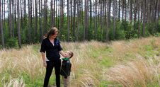 Pretty Young Mother Looking Down Into Smiling Son S Face While Out In Meadow Stock Photo