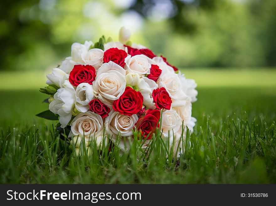 Wedding bouquet of roses in the grass