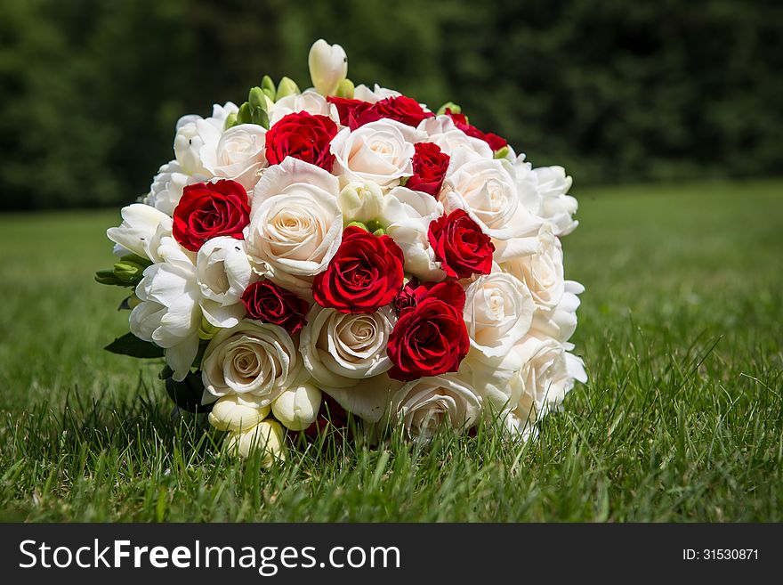 Wedding bouquet of roses in the grass