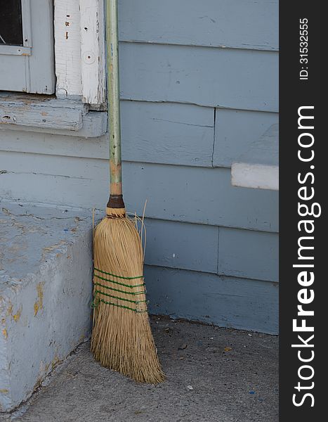 Old broom by building