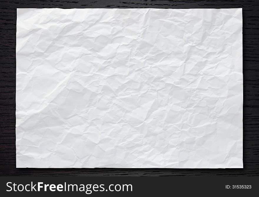 White Crumpled Paper On Dark Wood