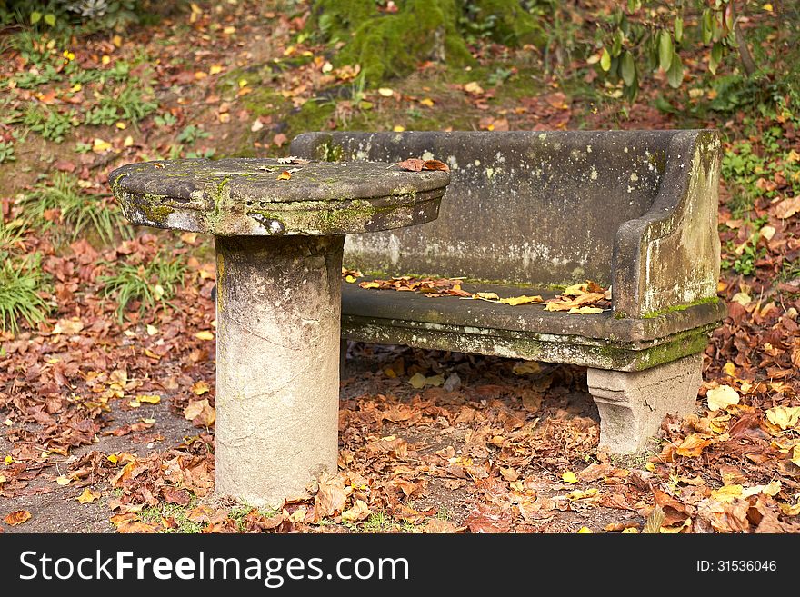 Old park table and bench in autumn garden. Old park table and bench in autumn garden.