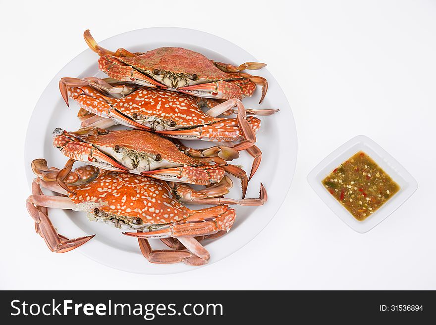 Steamed crabs with seafood sauce on white background