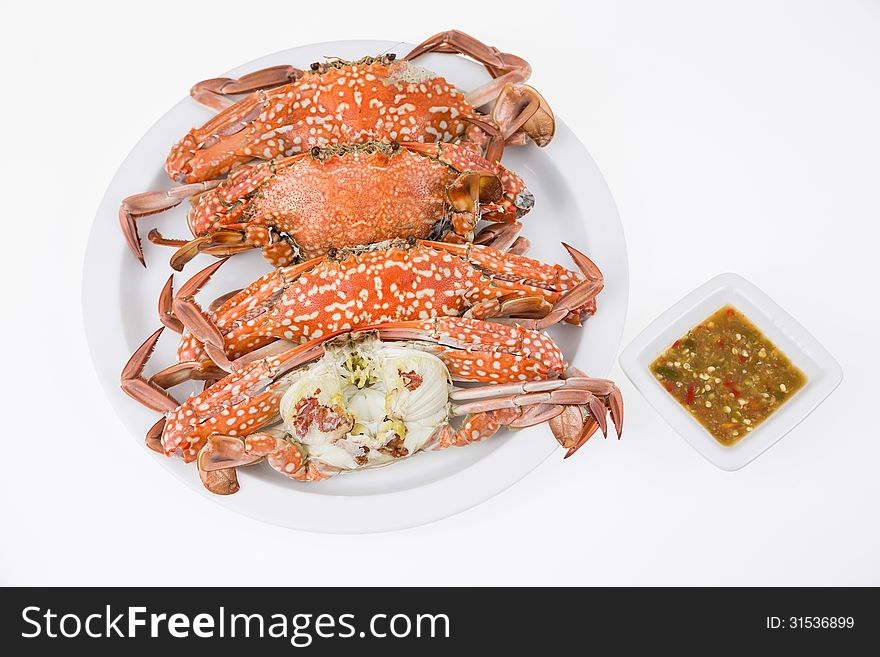 Steamed crabs with seafood sauce on white background