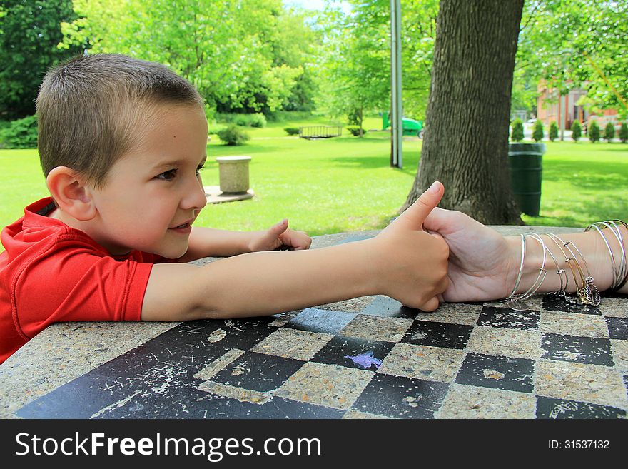 Young Boy Determined To Beat His Mom At Thumb Wrestling