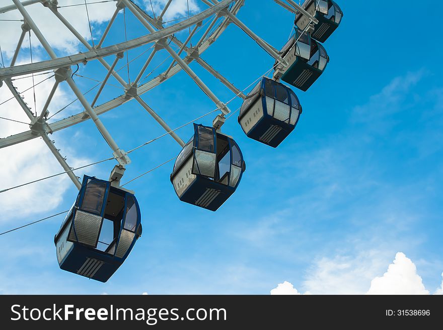 A part of ferrie wheel on a background of blue skies. A part of ferrie wheel on a background of blue skies