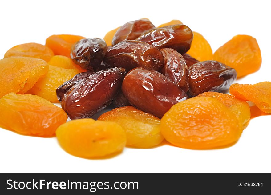 Apricots and dried dates on white background. Apricots and dried dates on white background